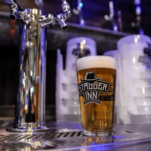 a pint of beer on a bar