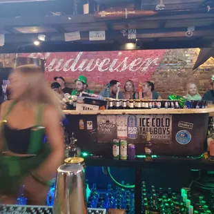 a woman in a bikini behind a bar