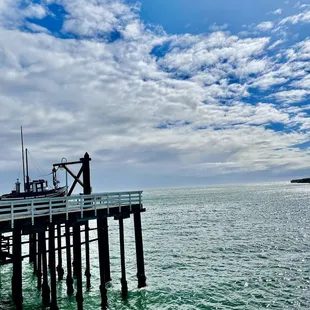a fishing boat docked at a pier
