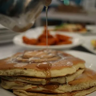 Cinnamon Roll Pancakes The traditional pastry treat meets our sweetest stak in a swirl of cinnamon delight with a vanilla glaze.