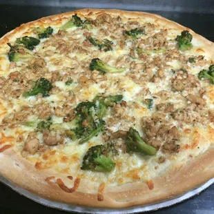 large chicken and broccoli pizza with Alfredo sauce on the base