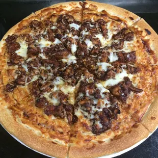 large BBQ chicken specialty pizza with roasted peppers, BBQ base and mozzarella cheese