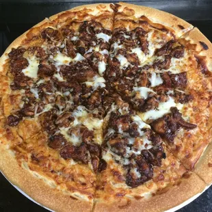 large BBQ chicken specialty pizza with roasted peppers, BBQ base and mozzarella cheese