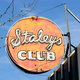 a neon sign on the side of a building