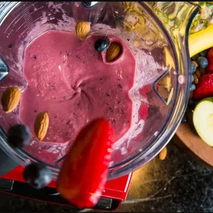 a blender filled with fruit and nuts