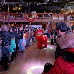 a crowd of people standing in a large room