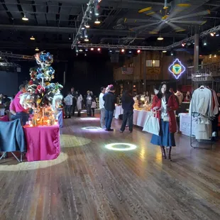 a group of people standing around a christmas tree