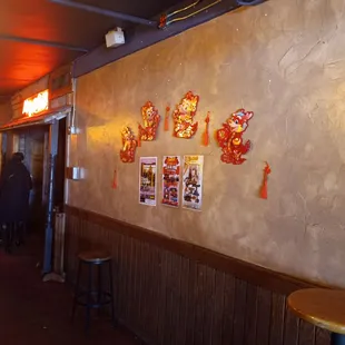 a restaurant with a wall decorated with chinese decorations