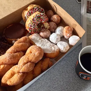 a box of donuts and a cup of coffee