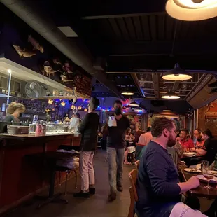 Interior dining area with the view of the bustling kitchen.