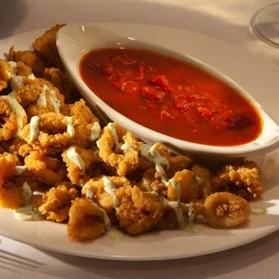 Stancato's Calamari Fritti - Lightly breaded and fried. Drizzled with a Basil Pesto Aioli and served with our Marinara Sauce.
