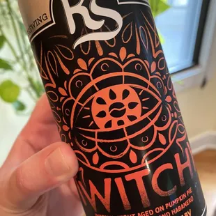 a person holding a can of beer