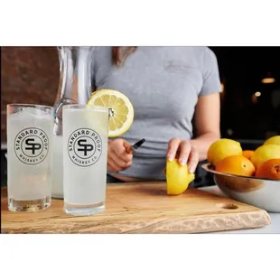 a woman holding a glass of lemonade