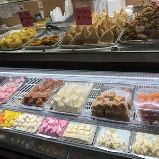 a variety of desserts in a display case