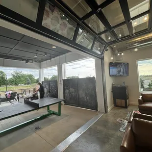 Under the covered patio is a ping pong table, a chalk board and lots of toys for kids to play with.