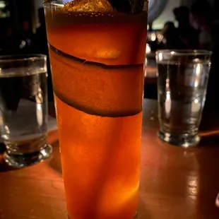 a tall glass of orange juice