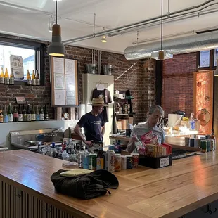 a man and a woman behind a bar