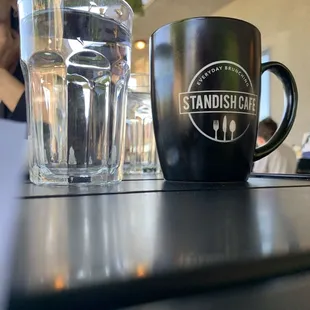 a glass of water and a coffee mug
