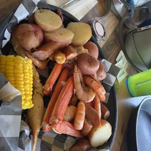 crab legs, potatoes, corn, and corn on the cob