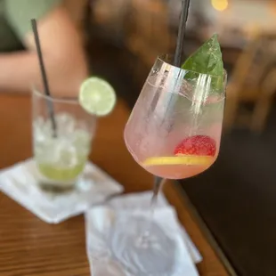 a glass of water and a spoon on a table