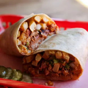 a burrito on a red tray