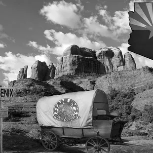 a covered wagon in front of a mountain