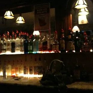 a row of liquor bottles on a bar