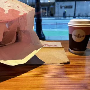 A bag of donuts with a cup of coffee.  Can&apos;t go wrong here!