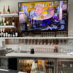 a bar with wine glasses on the counter