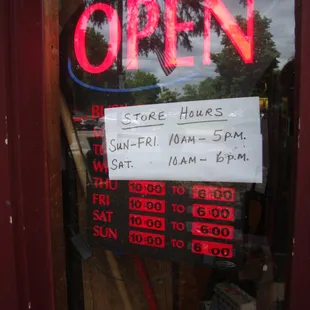 Hours of operation, adjacent to the front entry door.