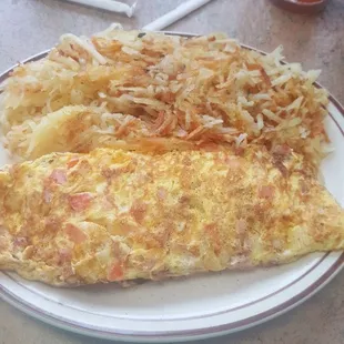 Ham cheese tomato onion omelet hash browns .