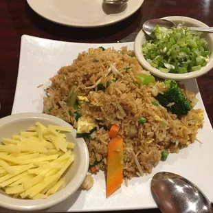 Vegetable fried rice with green onion and ginger garnish