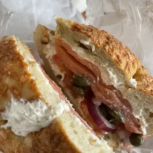 Asiago cheese bagel with lox, capers, onions