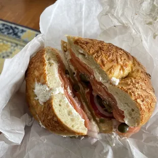 Asiago bagel with cream cheese, lox, onions, and capers