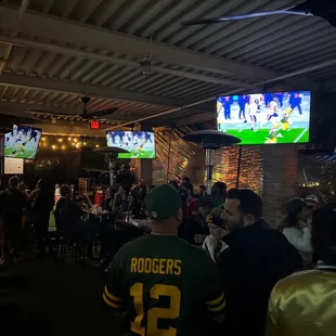 a large group of people watching a football game
