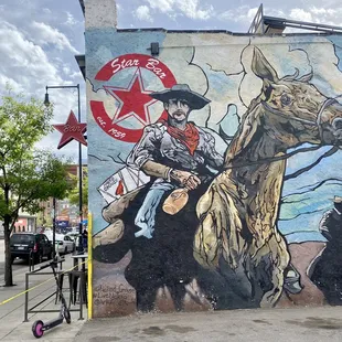 a cowboy on a horse with a red star