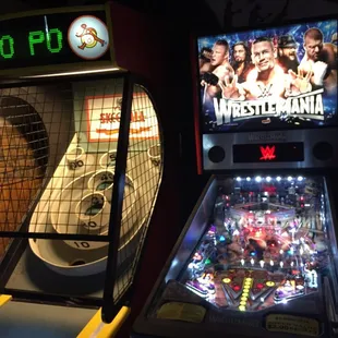 a pinball machine and a wrestling game