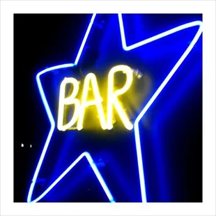 a neon sign with the word bar