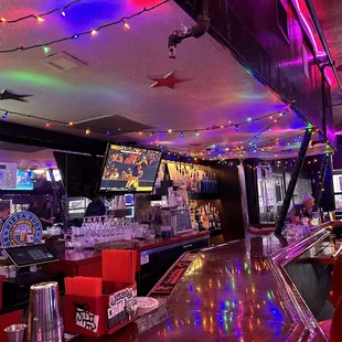 a brightly lit bar with red leather chairs