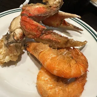 a plate of crab legs and fried shrimp