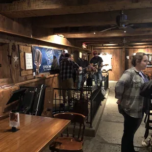 a group of people standing around a bar
