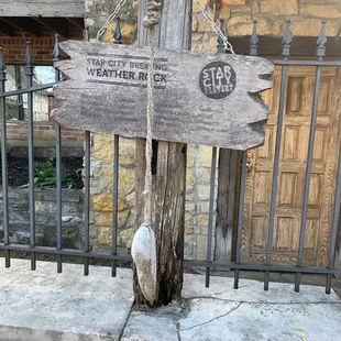 a wooden sign on a fence