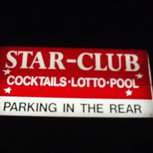 a red and white sign in the dark
