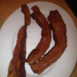 a plate of bacon on a table