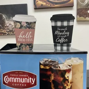 two coffee cups on a coffee cart