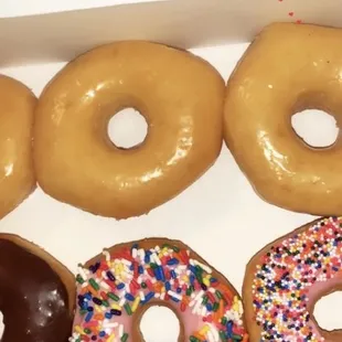 six different flavored donuts in a box