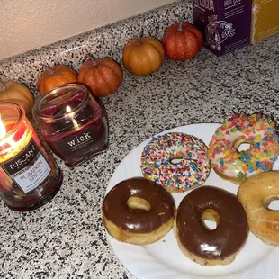 a plate of doughnuts and a candle