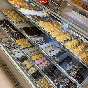 a variety of donuts in a display case