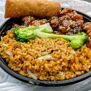 a plate of rice, broccoli, and meat