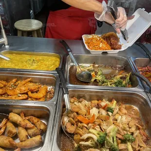 a person serving food at a buffet